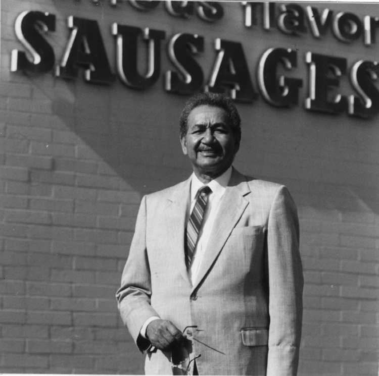 Raymond V. Haysbert Sr. in front of Parks Sausage